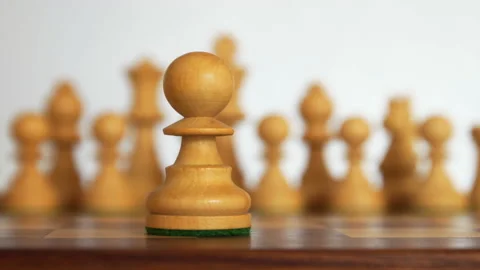 White chess figures on background and one pawn on foreground Stock Footage 135847400