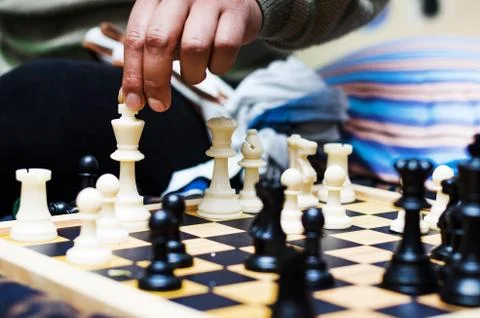 White chess king alone surrounded by the opposite pieces, selective focus on Stock Photos