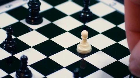 White chess pawn is surrounded by black pawns, ideal footage to represent Stock Footage 101638452