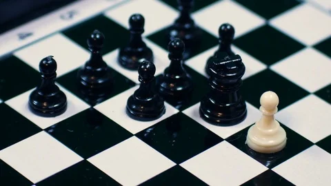 White chess pieces lined up against all black pawns, ideal footage to represent Stock Footage 101641742