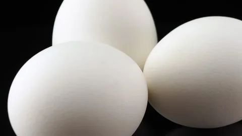 White chicken egg close up on black background Video stock 140614794