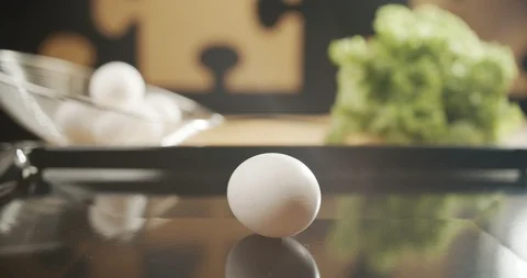 White chicken egg spinning in slow motion on table. 4K video Stock Footage 117292365