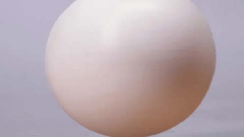 White chicken egg spinning on a white background or white table. Nutrition Stock Footage 150565657