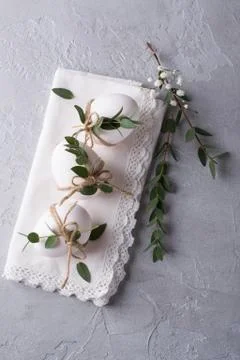 White chicken eggs with easter decor on a white napkin. Home decor trend Stock Photos