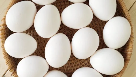 White chicken eggs rotating in a wicker basket Stock Footage 335836651