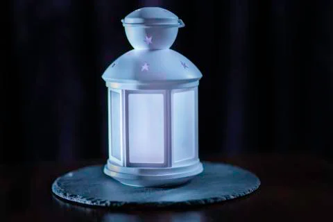 White children's lamp on a stone stand and on a dark background Stock Photos