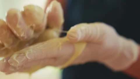 White chocolate ball rolled between two hands Stock Footage 274632261