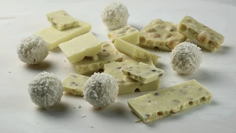White chocolate bars and round chocolate candies spin Stock Footage 127116017