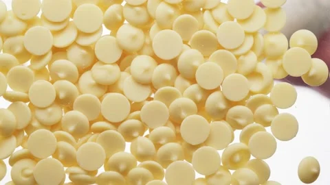White chocolate chips falling on transparent background, bottom view. Stock Footage 155507116
