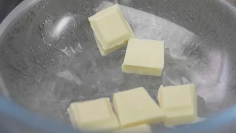 White Chocolate Chunks Dropped in Boiling Bain Marie Stock Footage 166863205