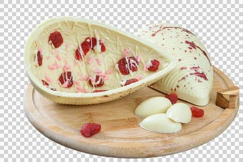 A white chocolate Easter egg with candied strawberries on a wooden plate. Stock Photos