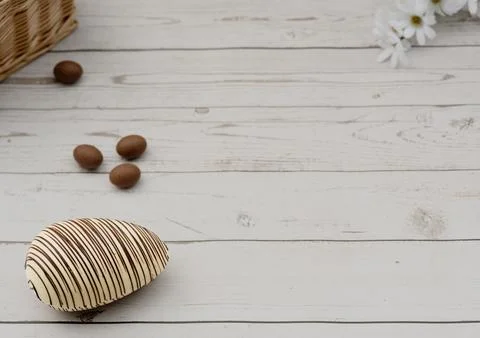 White Chocolate Easter Egg  with dark  lines on Rustic Wooden Background Stock Photos