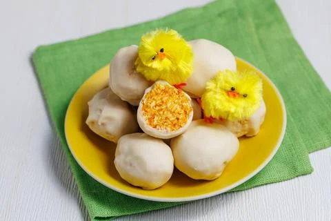 White chocolate easter eggs with orange dried apricot filling. Sweet candy .. Stock Photos