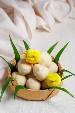 White chocolate easter eggs. Sweet candy eggs in nest on white table with yellow Stock Photos