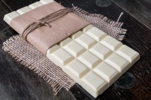 White chocolate tablet on rustic background Stock Photos