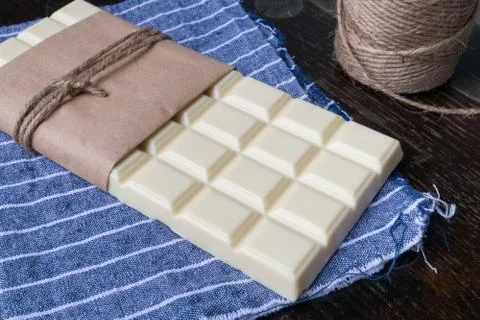 White chocolate tablet on rustic background Stock Photos