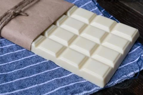 White chocolate tablet on rustic background Stock Photos