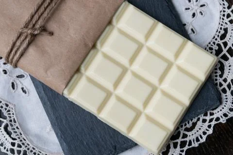 White chocolate tablet on rustic background Stock Photos