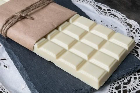 White chocolate tablet on rustic background Stock Photos
