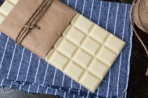 White chocolate tablet on rustic background Stock Photos