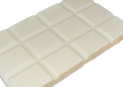 White chocolate on a white background Photos