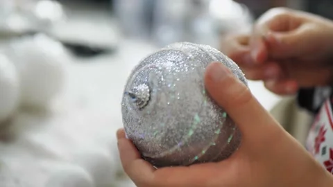 White Christmas tree ball boy touches the hook for the ball Stock Footage 201821306