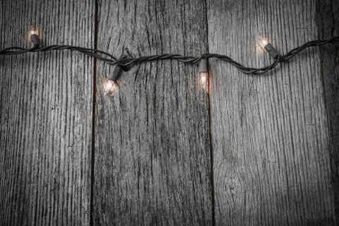 White christmas tree lights with rustic wood background Stock Photos