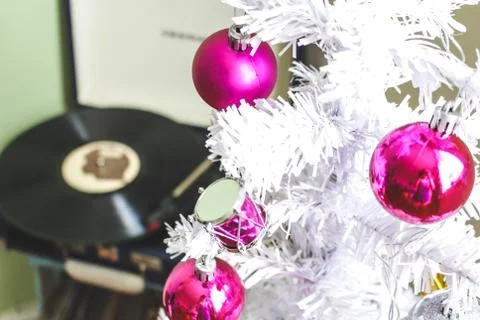 White christmas tree with pink balls and record player in the background Stock Photos