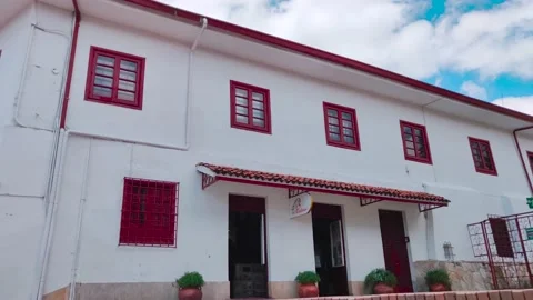 White church with red frame windows on top of the Monserrate cable car in Stock Footage 150192908