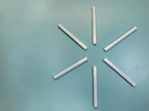 White cigarettes on a blue table Stock Photos