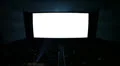 White cinema screen with projector light and audience in a modern cinema house. HD Footage