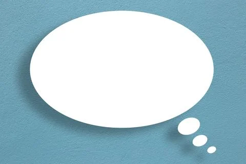 White circle paper speech bubble shape against dark blue wall color backgroun Stock Photos