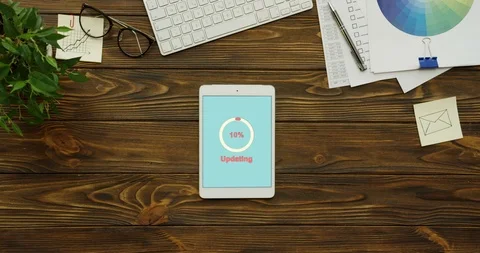 White circle with percents on the blue screen updating the white tablet device Stock Footage 95103533