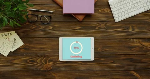 White circle with percents on the blue screen updating the white tablet device Stock-Footage 95115567