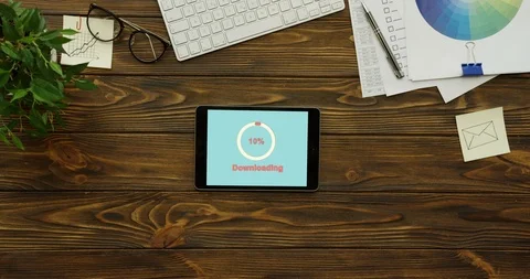 White circle of red percents loading in the blue screen of the black tablet Stock Footage 95057775