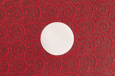 White circle on red swirl patterned background with glitter accents Stock Photos