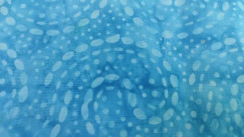 White circular dots on a turquoise fabric Stock Footage 260202278