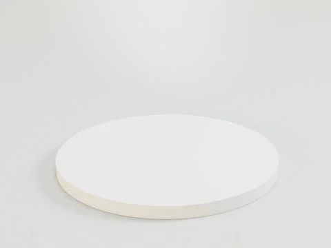 A white circular object with a foam or sponge-like center sits on a flat su.. Stock Illustration