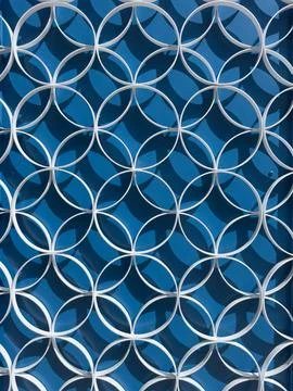 White circular pattern metal grill over blue wall 스톡 일러스트