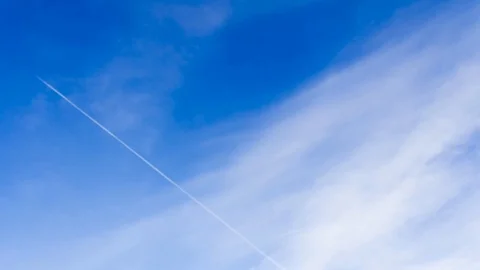 White cirrus cloud and vapour trails from jet planes in blue sky timelapse. Stock Footage 86359669