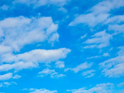 White cirrus clouds float in the blue sky. Full screen photo Stock Photos