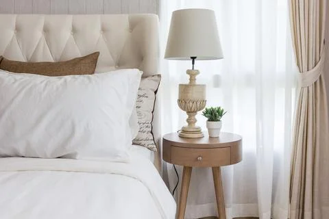 White classic lamp on table side in bedroom with at home Stock Photos