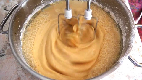 A white classic mixer whips yellow dough for biscuits, Russian pancakes Stock Footage 121573953