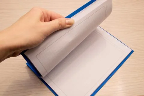 White clean notebook in a cage for notes lies on a wooden background and a wo Stock Photos