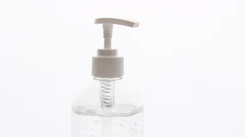 A white clear plastic bottle with transparent hand sanitizer gel isolated on Stock Footage 128330609