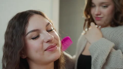 White Client Enjoying Final Styling Reveal While Friend Adjusts Curls Gentle Stock Footage 327023674