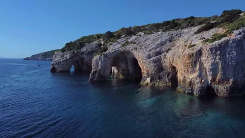 White cliffs and caves at the blue sea of Zakynthos. Blue caves drone shot Stock Footage 266685340