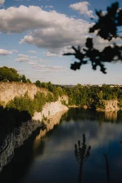White cliffs reflecting in tranquil waters of Zakrzowek Lagoon at sunset Stock-Fotos