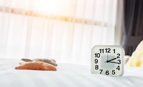 White clock and white bed Stock Photos