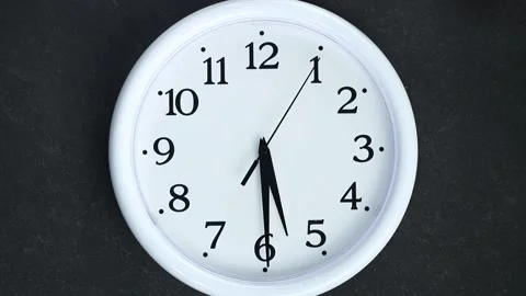 White clock on black background. The second hand goes to 6 o'clock. Evening or Stock Footage 165915126